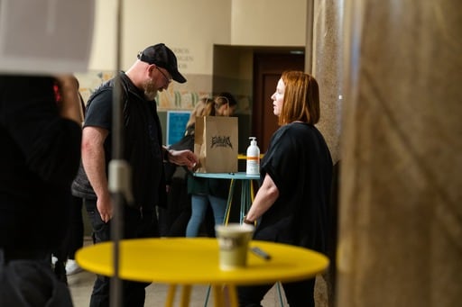 A man and a woman having a discussion in the foyer