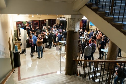 People in the foyer, shot from the stairs