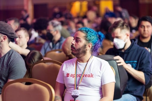 A man with an AppTweak t-shirt in the audience
