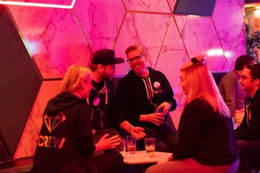 A group of people in Crew hoodies at the party